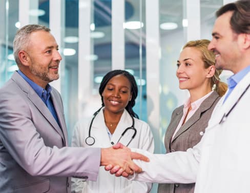 Group meeting of professionals and doctors shaking hands