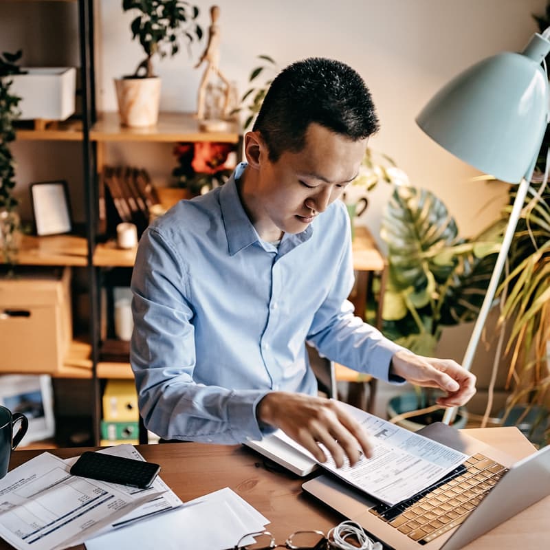 man looking at printed forms