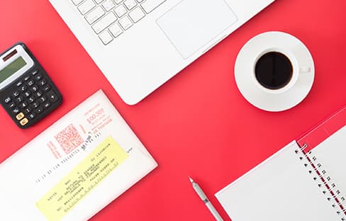 Woman sorting through mail at desk