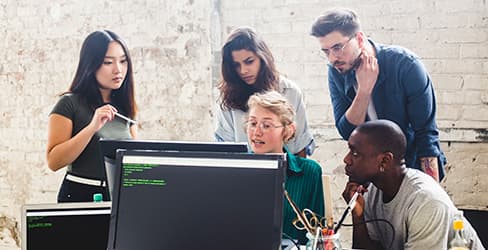 co workers looking at computer screen