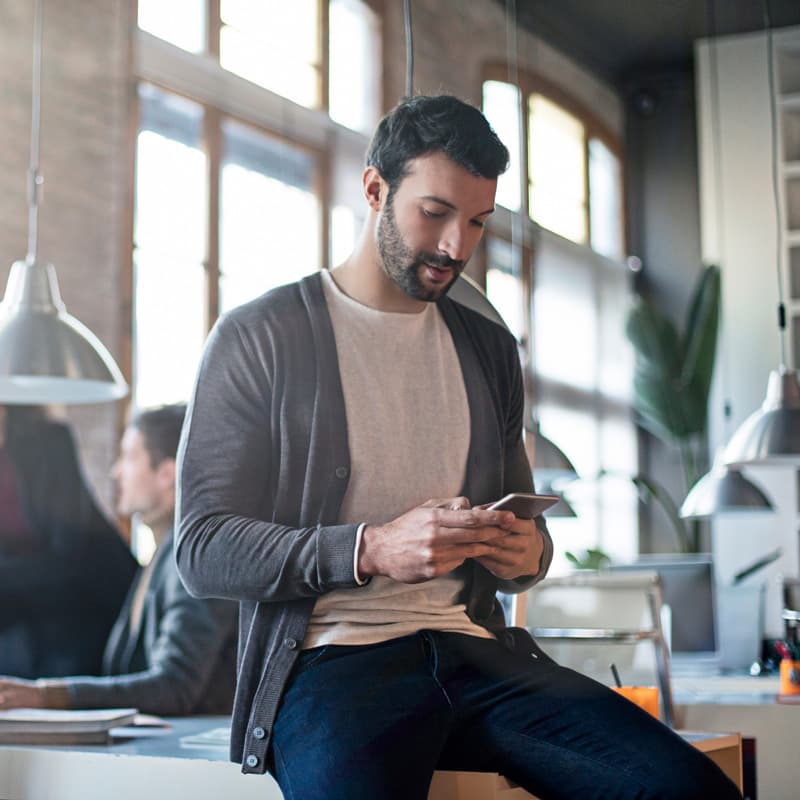 Man in office on mobile phone