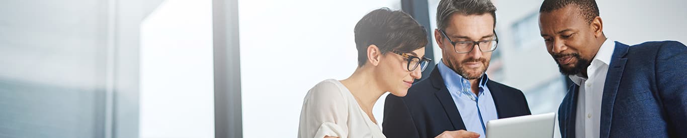 3 business people looking at a tablet
