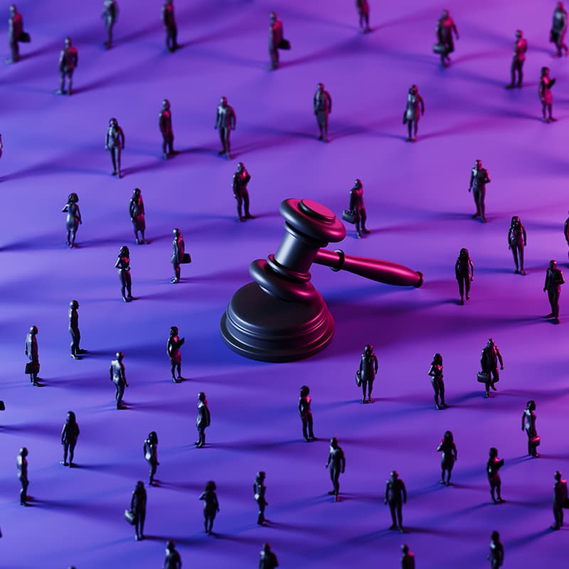 Large gavel surrounded by digital micro business professionals in a conceptual workplace setting, representing human resources, legal careers, corporate governance, and organizational compliance.