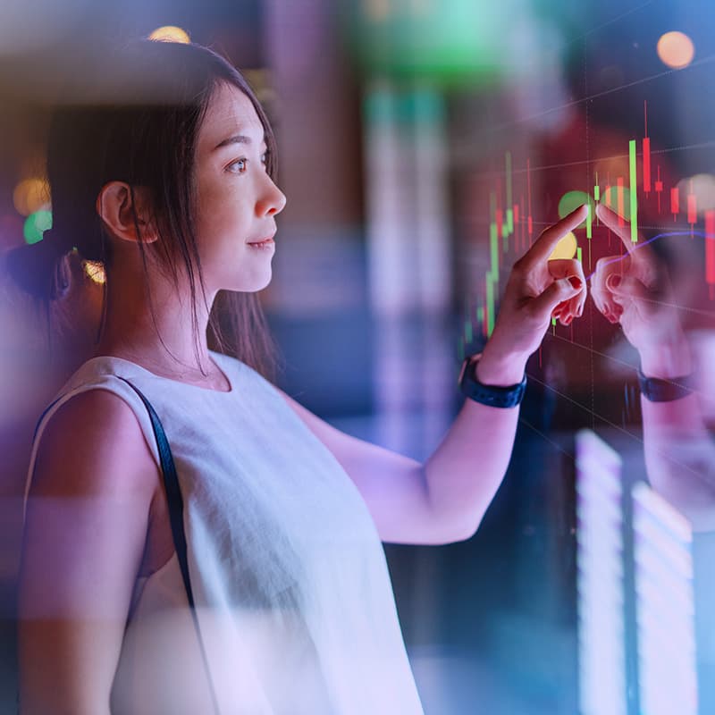 Young businesswoman analysing data, touching on digital display. Futuristic concepts. Future technology.