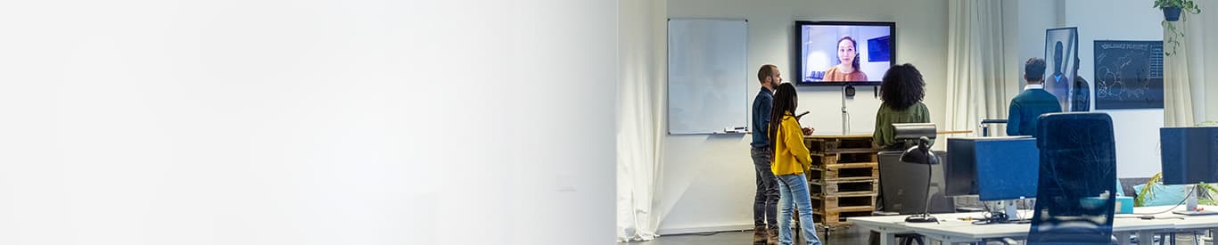 Team of employees in the office having a meeting with remote teamates