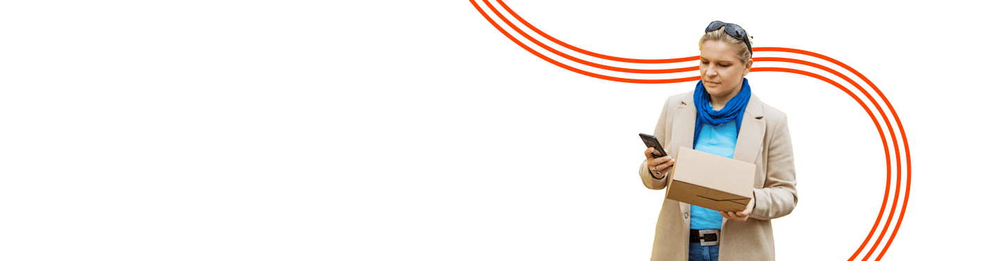 Woman holding a package while looking at her phone