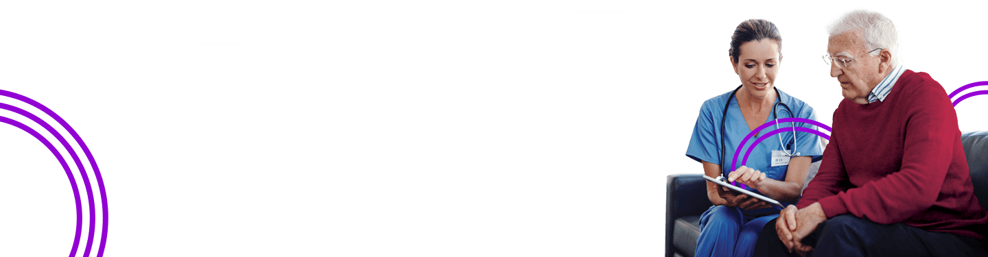 Nurse and man sitting on couch looking at a tablet