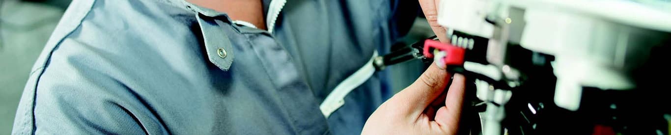 Closeup photo of a man working on a machine.