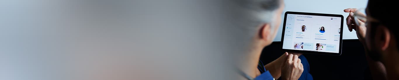 Two doctors looking at patient data on digital tablet