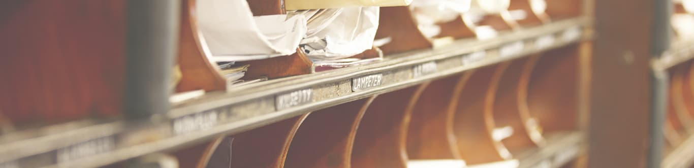 Close up of mailroom with mail sorted in slots