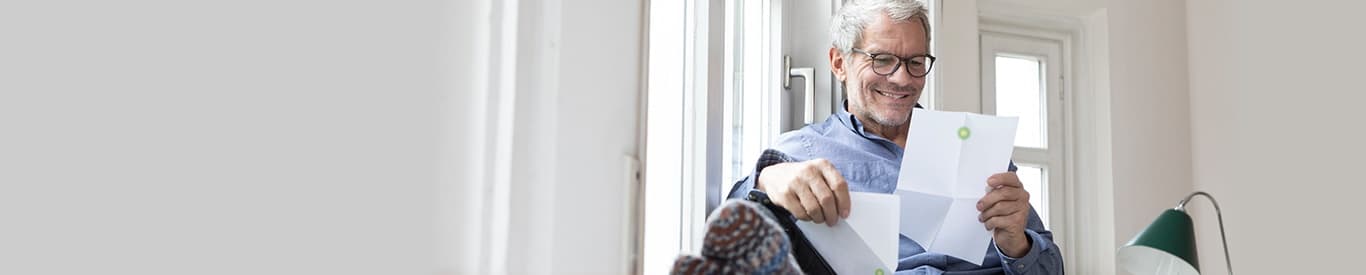 Man reading energy mail at home